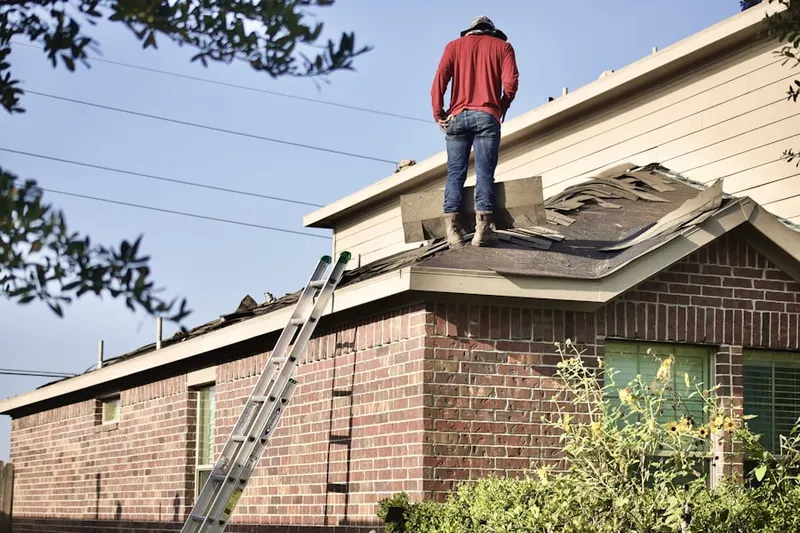 Professional roofer working on a residential roof in Randalia